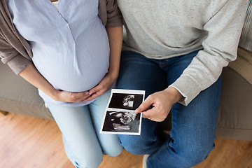 Image showing close up of couple with baby ultrasound images