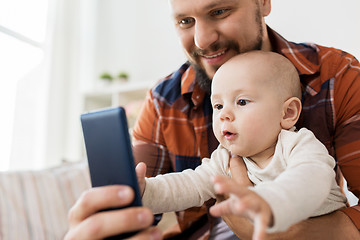 Image showing happy father with baby boy taking selfie at home