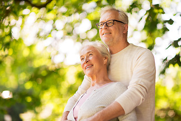 Image showing happy senior couple hugging at summer park