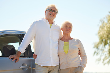 Image showing happy senior couple hugging at car in summer