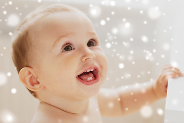 Image showing face of happy little baby boy or girl looking up