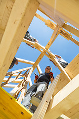 Image showing Builders at work with wooden roof construction.