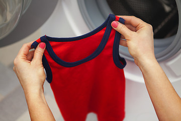 Image showing red T-shirt in the hands 