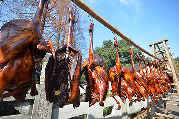 Image showing Rows of cured meat hanging to dry