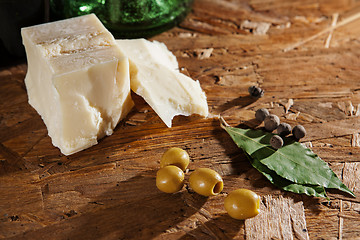 Image showing cheese and olives on wooden surface