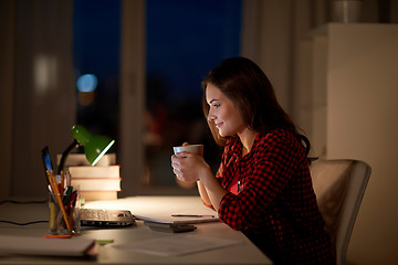 Image showing student woman with laptop and coffee at night home