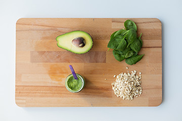 Image showing jar with puree or baby food on wooden board