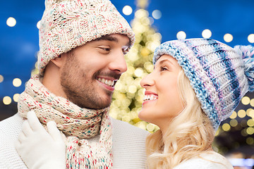 Image showing close up of happy couple over christmas lights