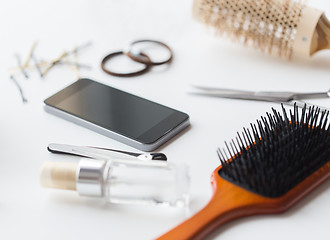 Image showing smartphone, scissors, brushes and other hair tools