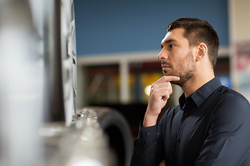 Image showing male customer choosing wheel rims at car service