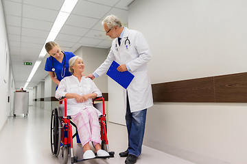 Image showing medics and senior patient in wheelchair at clinic