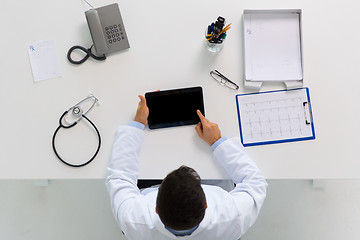 Image showing doctor with tablet pc and cardiogram at clinic