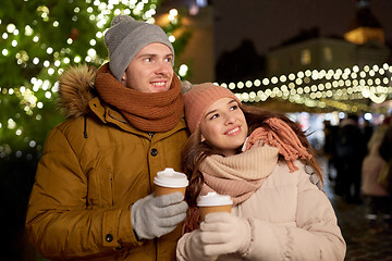 Image showing happy young couple with coffee at christmas market