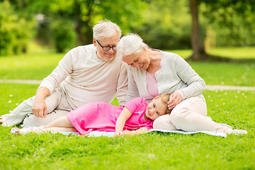 Image showing senior grandparents and granddaughter at park