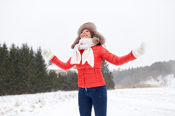 Image showing happy woman in winter fur hat having fun outdoors