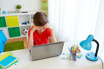 Image showing tired student boy with laptop computer at home