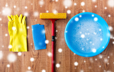 Image showing squeegee with window cleaning stuff on wood