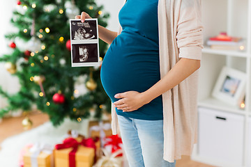 Image showing pregnant woman with ultrasound images at christmas