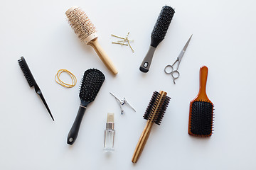 Image showing scissors, hair brushes, clips and styling spray