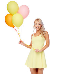 Image showing happy woman in dress with helium air balloons