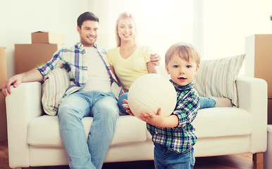 Image showing happy little boy with ball over parents at home