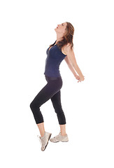 Image showing Slim woman in profile, stretching.