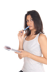 Image showing Woman standing with pen in her mouth.