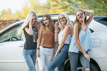 Image showing The young women standing near the car