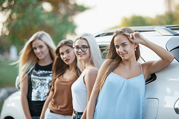 Image showing The young women standing near the car