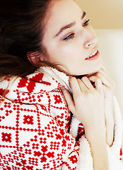 Image showing young pretty brunette girl in Christmas ornament blanket getting