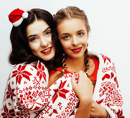 Image showing young pretty happy smiling blond and brunette woman girlfriends on christmas in santas red hat and holiday decorated plaid, lifestyle people concept 