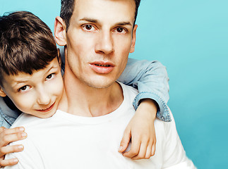 Image showing young pretty man model with little cute son playing together, lifestyle modern people concept, family male