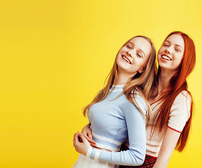 Image showing lifestyle people concept: two pretty young school teenage girls having fun happy smiling on yellow background 
