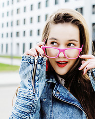 Image showing young pretty brunette business woman posing against modern building, lifestyle people concept 