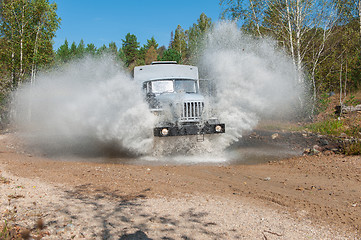 Image showing truck passes through a puddle