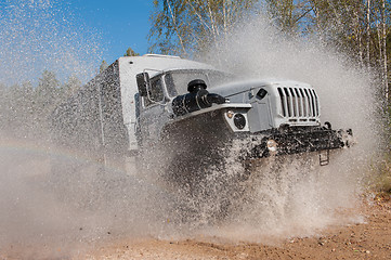 Image showing truck passes through a puddle