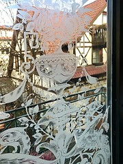 Image showing Ancient half-timbered house as seen through a richly decorated window