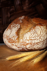 Image showing Homemade bread loaf on old cutting board