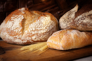 Image showing Fresh homemade bread assortment on old cutting board