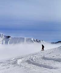 Image showing Snowboarder on off-piste slope with newly fallen snow
