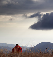 Image showing Man resting at mountains in evening