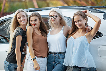 Image showing The young women standing near the car