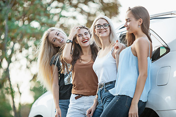 Image showing The young women standing near the car