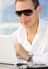 Image showing businessman on leisure with laptop