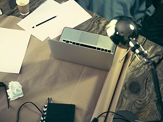 Image showing Vintage hipster wooden desktop top view