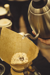 Image showing Barista pouring water to coffee