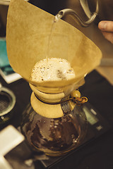 Image showing Barista pouring water to coffee