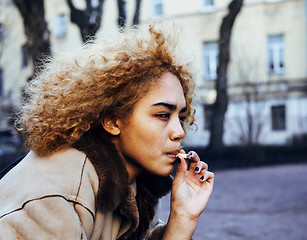 Image showing young pretty girl teenage outside smoking cigarette close up, lo