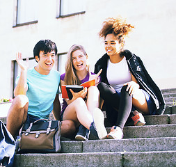 Image showing cute group of teenages at the building  university with books huggings, back to school