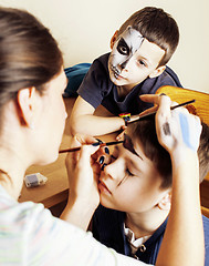 Image showing little cute child making facepaint on birthday party, zombie Apo